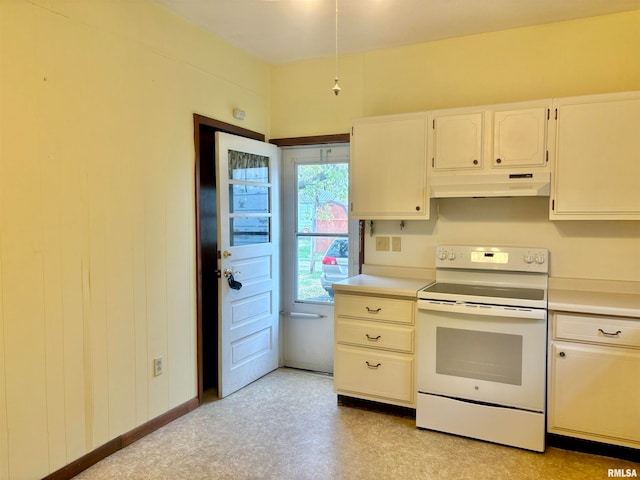 kitchen featuring white electric stove and white cabinetry