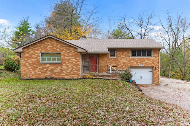 view of front of property with a front lawn and a garage