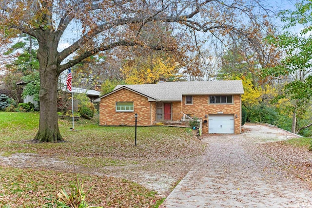 tri-level home featuring a garage and a front lawn