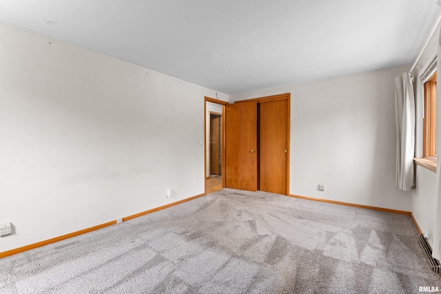 unfurnished room featuring light carpet