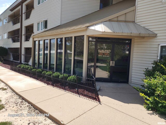 view of exterior entry featuring a balcony