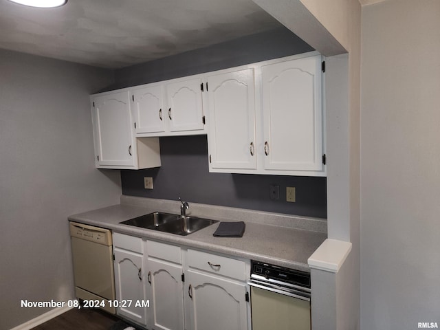 kitchen featuring sink, white dishwasher, and white cabinets