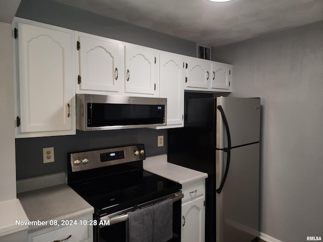 kitchen with stainless steel appliances and white cabinetry