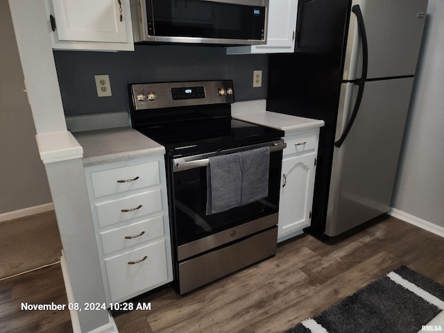 kitchen featuring white cabinets, dark hardwood / wood-style flooring, and appliances with stainless steel finishes