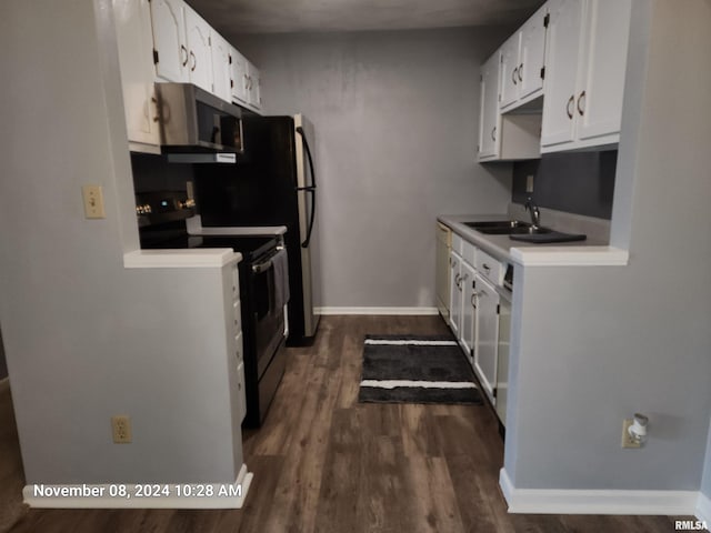 kitchen featuring dark hardwood / wood-style floors, white cabinetry, sink, and appliances with stainless steel finishes