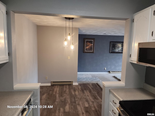 kitchen with stainless steel appliances, white cabinets, dark hardwood / wood-style flooring, pendant lighting, and a baseboard heating unit