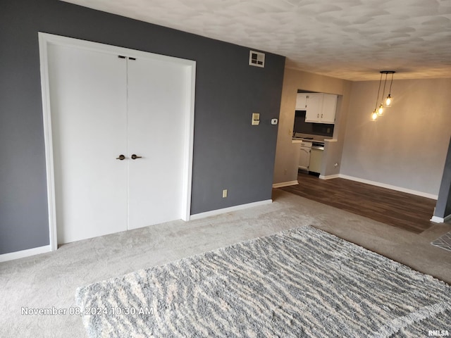 empty room featuring a textured ceiling and hardwood / wood-style flooring