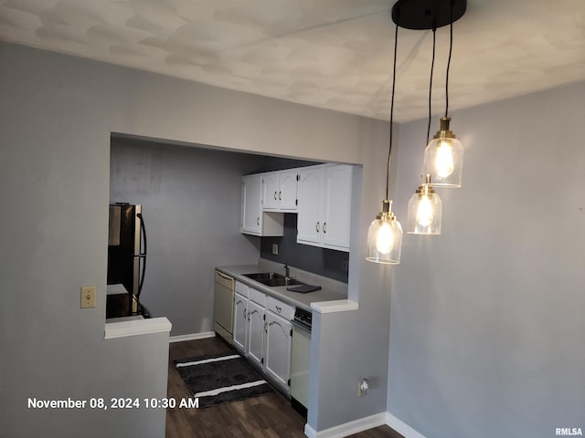 kitchen featuring stainless steel appliances, white cabinets, hanging light fixtures, sink, and dark hardwood / wood-style floors