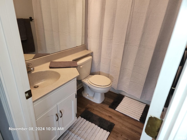 bathroom featuring hardwood / wood-style floors, vanity, and toilet