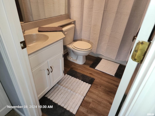 bathroom with vanity, hardwood / wood-style flooring, and toilet