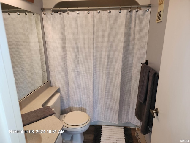 bathroom with wood-type flooring and toilet