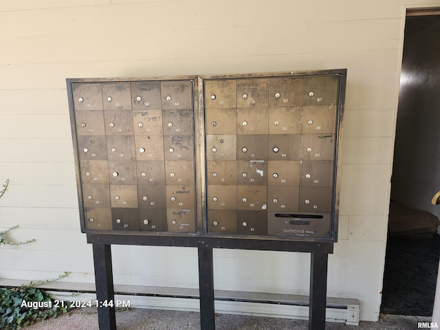 exterior details featuring mail boxes and wooden walls