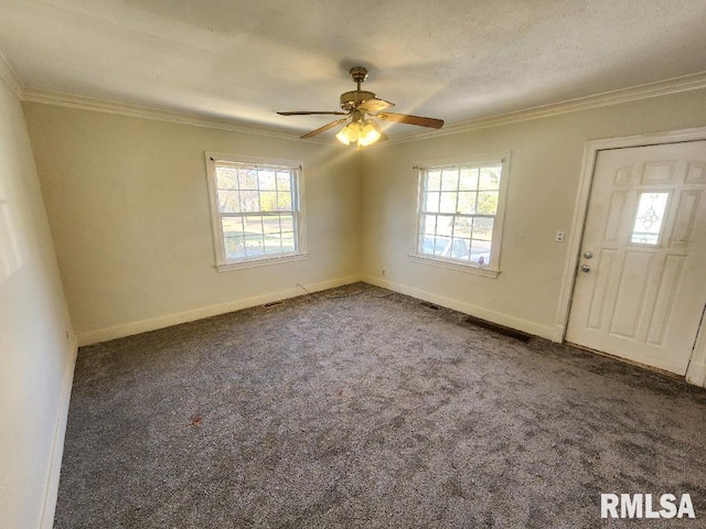 entryway with dark colored carpet, ceiling fan, and crown molding