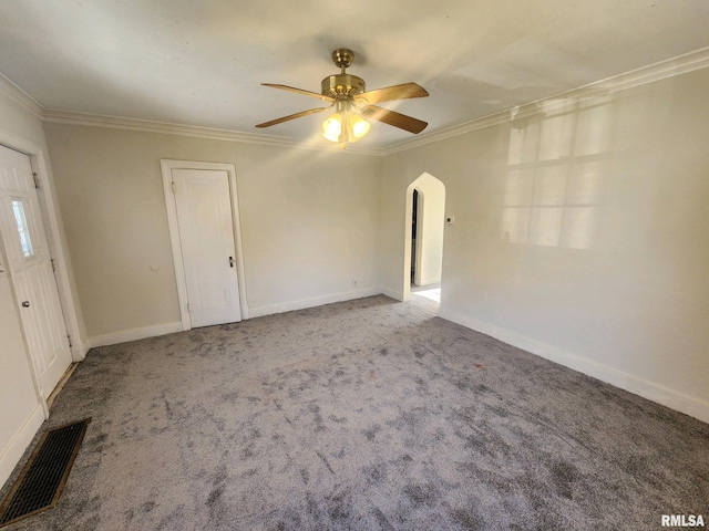 carpeted spare room with ceiling fan and ornamental molding