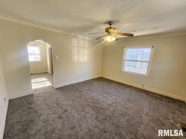 unfurnished room with crown molding, carpet floors, a healthy amount of sunlight, and ceiling fan