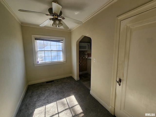 unfurnished bedroom featuring ceiling fan, carpet floors, and ornamental molding