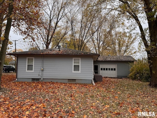 back of house featuring a garage