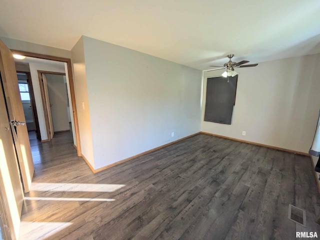 unfurnished room featuring dark hardwood / wood-style floors and ceiling fan