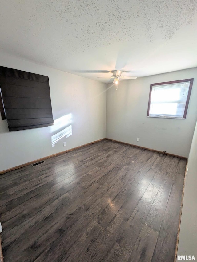 unfurnished room featuring a textured ceiling, ceiling fan, and dark hardwood / wood-style floors