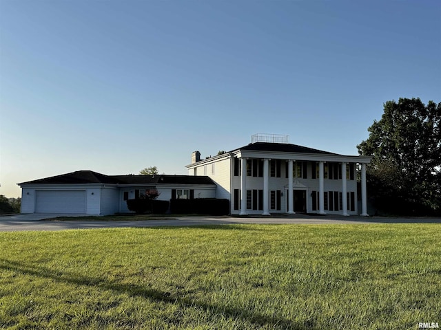 2001 Wigwam Hollow Rd, Macomb, IL 61455 - greek revival house featuring an attached garage, a front lawn, and driveway
