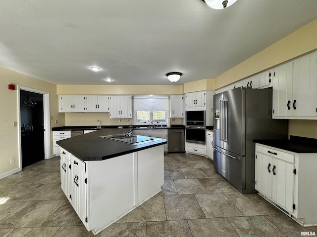 2001 Wigwam Hollow Rd, Macomb, IL 61455 - kitchen with stainless steel appliances, dark countertops, and white cabinetry