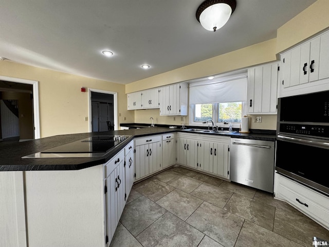 2001 Wigwam Hollow Rd, Macomb, IL 61455 - kitchen with appliances with stainless steel finishes, dark countertops, a peninsula, recessed lighting, and white cabinets