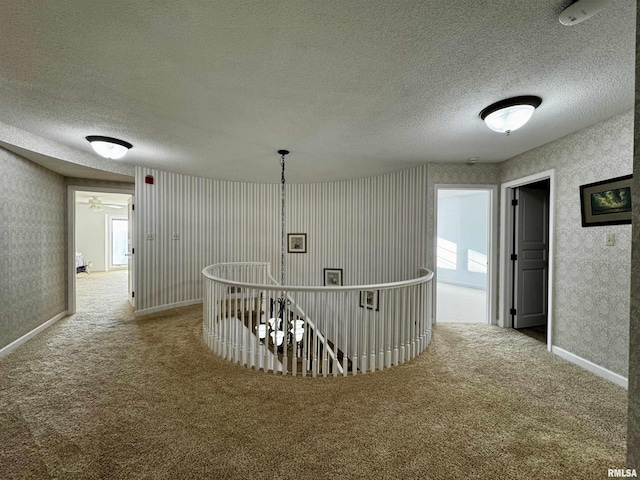 2001 Wigwam Hollow Rd, Macomb, IL 61455 - corridor with carpet floors, a textured ceiling, and an upstairs landing