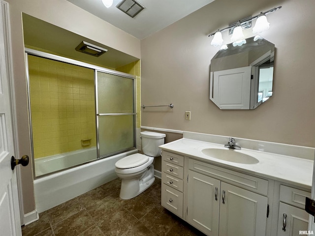 full bathroom with toilet, vanity, and bath / shower combo with glass door