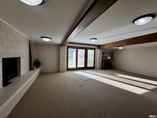2001 Wigwam Hollow Rd, Macomb, IL 61455 - unfurnished living room featuring a large fireplace, carpet, concrete block wall, and crown molding