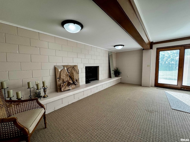 unfurnished living room with a fireplace, carpet, ornamental molding, and beam ceiling