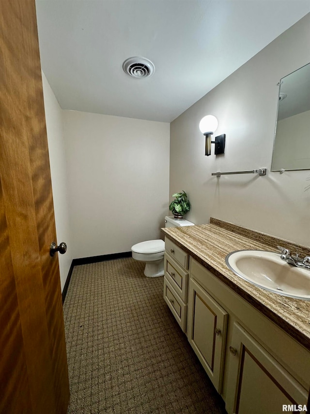 bathroom featuring toilet and vanity