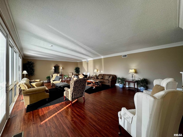 living room with wood-type flooring, a textured ceiling, and crown molding