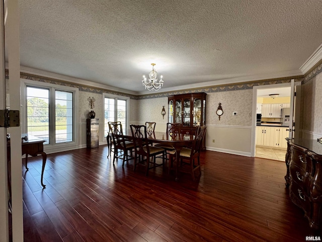 dining area with a textured ceiling and dark hardwood / wood-style flooring