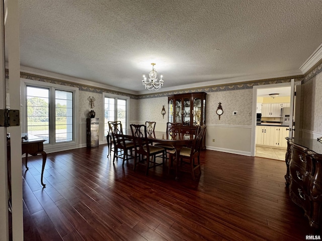 2001 Wigwam Hollow Rd, Macomb, IL 61455 - dining area featuring crown molding, a chandelier, a textured ceiling, wallpapered walls, and hardwood / wood-style floors