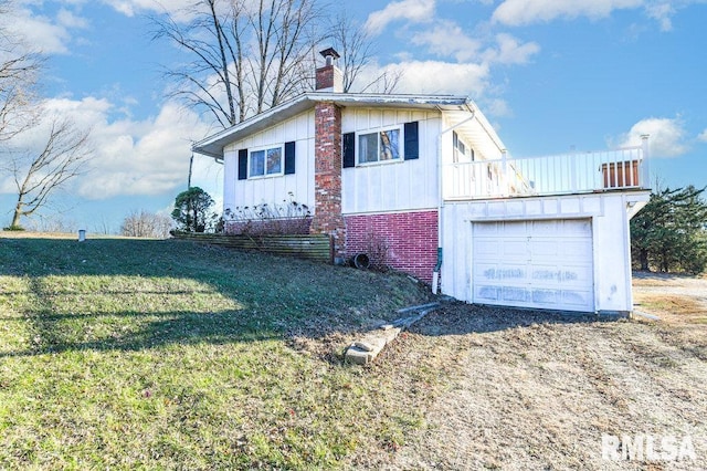 view of side of property with a balcony, a garage, and a lawn