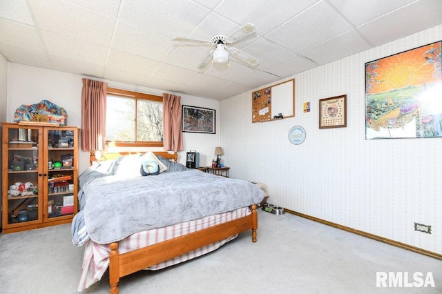 carpeted bedroom featuring a paneled ceiling and ceiling fan