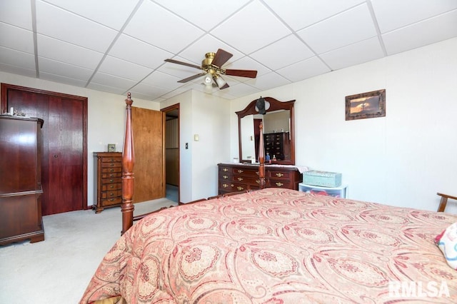 bedroom featuring a paneled ceiling, ceiling fan, and light colored carpet