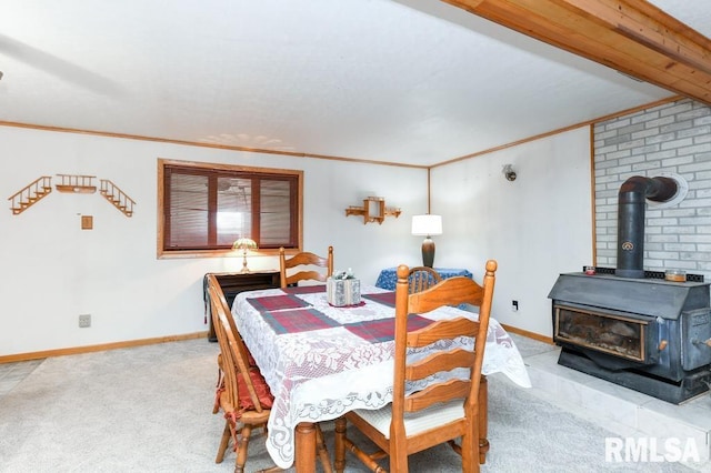 dining area featuring a wood stove, light carpet, and crown molding