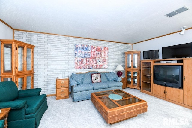 carpeted living room featuring crown molding and brick wall