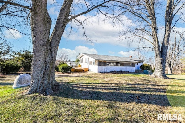 exterior space featuring a front lawn and a deck