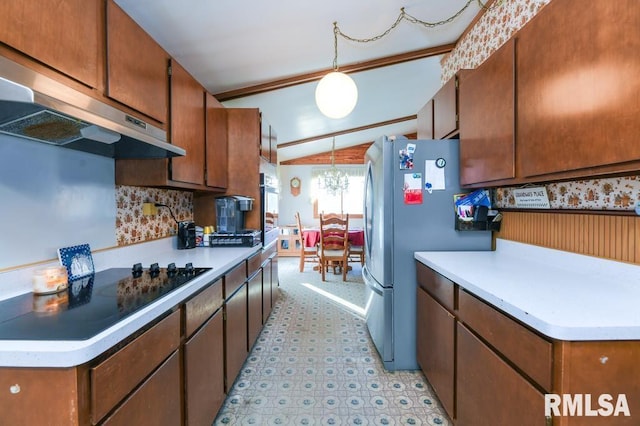 kitchen with stainless steel fridge, black cooktop, extractor fan, vaulted ceiling, and decorative light fixtures