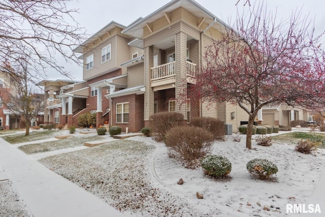 snow covered property featuring cooling unit