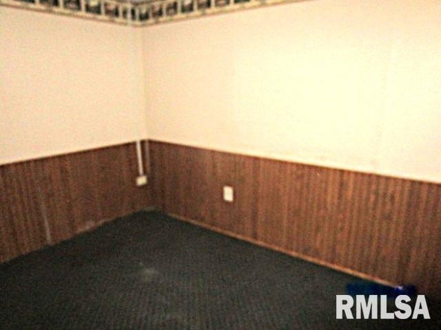 empty room featuring wooden walls