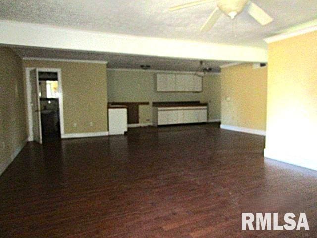 empty room featuring ornamental molding, ceiling fan, and dark hardwood / wood-style floors