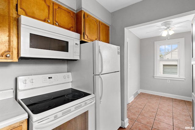 kitchen with white appliances, ceiling fan, and light tile patterned flooring