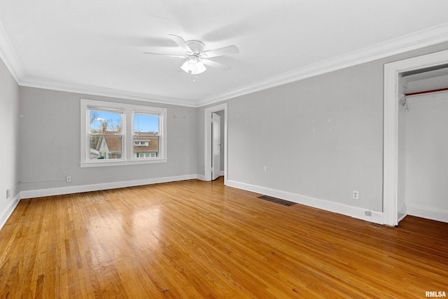 unfurnished bedroom featuring a closet, light hardwood / wood-style floors, ceiling fan, and crown molding