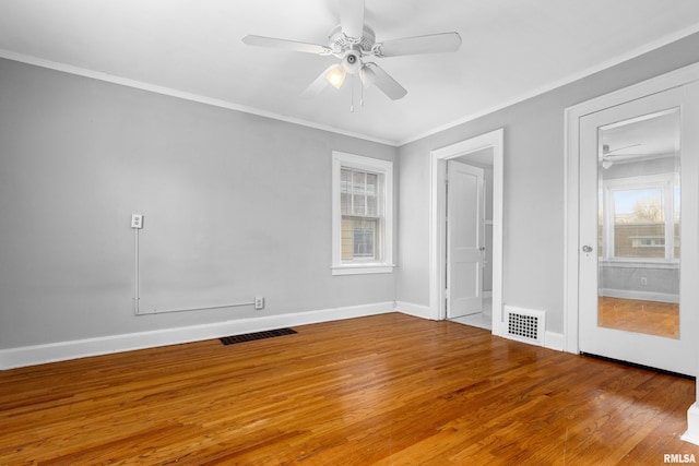 unfurnished bedroom with ceiling fan, ornamental molding, and hardwood / wood-style flooring