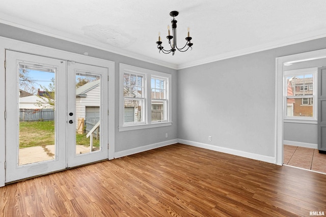 doorway featuring light hardwood / wood-style floors, crown molding, and a healthy amount of sunlight