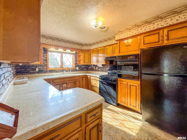 kitchen featuring sink, black appliances, kitchen peninsula, a textured ceiling, and decorative backsplash