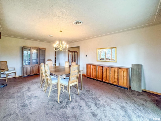 carpeted dining room with a chandelier and a textured ceiling